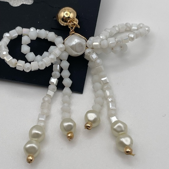NWT nOir Jewelry White Beaded Pearlescent Bow Earrings with Gold Tone Accents - Picture 2 of 3